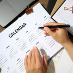 Close up of person looking at a yearly calendar