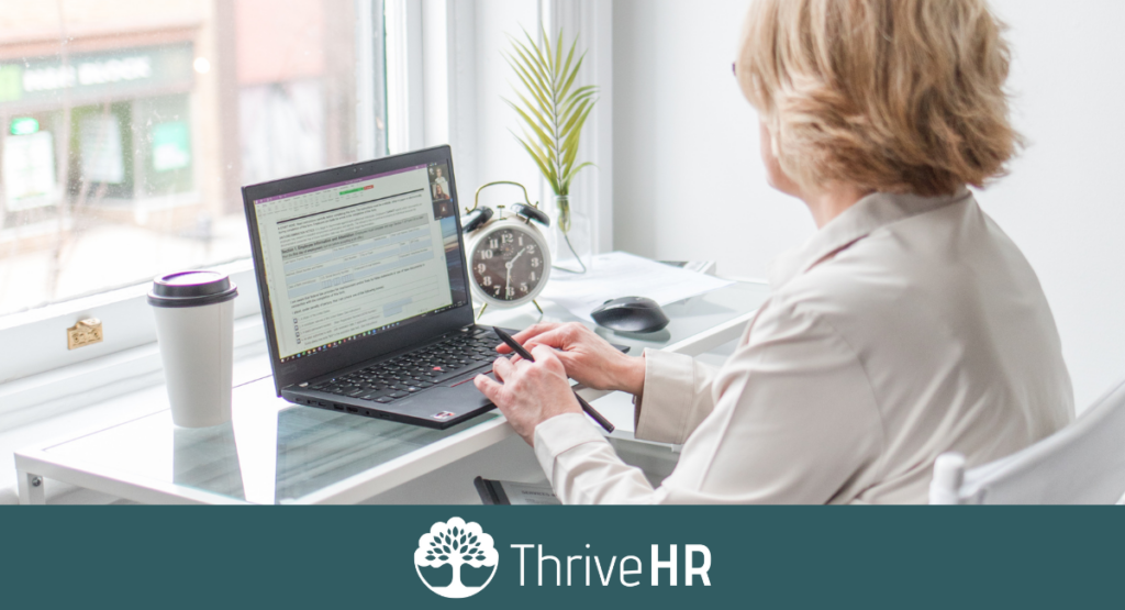 Woman at desk completing essential HR updates