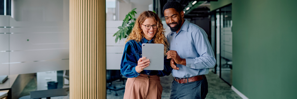 HR team using a tablet to evaluate candidates through a skills-based hiring process in a modern workplace